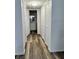 Hallway with modern flooring and access to an updated bathroom and multiple storage closets at 2690 Coral Landings Blvd # 217, Palm Harbor, FL 34684