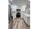 Well-lit kitchen equipped with stainless steel appliances, white cabinetry, and quartz countertops at 2690 Coral Landings Blvd # 217, Palm Harbor, FL 34684