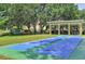 Community shuffleboard courts with nearby playground and shaded seating area at 2690 Coral Landings Blvd # 217, Palm Harbor, FL 34684