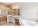 Gorgeous bathroom with a glass-enclosed shower and soaking tub at 30764 Lindentree Dr, Wesley Chapel, FL 33543