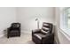 Bedroom featuring leather armchairs and a window for natural light at 30764 Lindentree Dr, Wesley Chapel, FL 33543