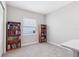 Bedroom with two bookcases, neutral carpet, and a window for natural light at 30764 Lindentree Dr, Wesley Chapel, FL 33543