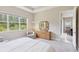 Relaxing bedroom featuring a large window with views of the lush greenery outside at 30764 Lindentree Dr, Wesley Chapel, FL 33543