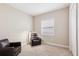 Bedroom featuring a recliner chair and a window for natural light at 30764 Lindentree Dr, Wesley Chapel, FL 33543