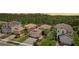 Aerial image of a two story home with a well-manicured lawn and backyard trees at 30764 Lindentree Dr, Wesley Chapel, FL 33543
