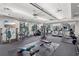 A well-equipped community gym with lots of exercise equipment, fans and windows at 30764 Lindentree Dr, Wesley Chapel, FL 33543