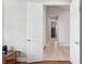 Hallway with white doors and light tile flooring, providing access to other rooms in the home at 30764 Lindentree Dr, Wesley Chapel, FL 33543