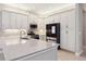 Bright kitchen with white cabinets, stainless steel appliances, and quartz countertops at 30764 Lindentree Dr, Wesley Chapel, FL 33543