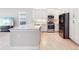 Modern kitchen featuring an island, stainless steel appliances, and white cabinetry with stylish backsplash at 30764 Lindentree Dr, Wesley Chapel, FL 33543
