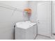 Clean laundry room featuring a washer and dryer, storage shelf, and access to the exterior at 30764 Lindentree Dr, Wesley Chapel, FL 33543