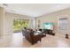 Open living room with tile flooring, sliding glass doors, and comfortable seating arrangement at 30764 Lindentree Dr, Wesley Chapel, FL 33543