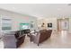 Living room merges with kitchen, offering tile floors, modern appliances, and an open, welcoming layout at 30764 Lindentree Dr, Wesley Chapel, FL 33543
