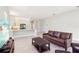 Open-concept living area connects to a stylish kitchen with island seating, enhancing the airy design at 30764 Lindentree Dr, Wesley Chapel, FL 33543