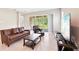 Comfortable living room with tile flooring, sliding doors to patio, and a modern TV setup at 30764 Lindentree Dr, Wesley Chapel, FL 33543