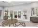 A well-decorated community lobby with a chandelier, mirrors, and modern furniture at 30764 Lindentree Dr, Wesley Chapel, FL 33543