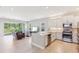 View of the open-concept kitchen and living area with a sliding glass door leading to the outside at 30764 Lindentree Dr, Wesley Chapel, FL 33543