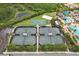 Aerial view showcasing the tennis and basketball courts, with a pool area, promoting an active lifestyle at 30764 Lindentree Dr, Wesley Chapel, FL 33543