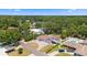 Aerial view of a home with large yard, nearby pool, and mature trees at 311 Jeanal Pl, Tampa, FL 33612