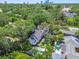 Aerial view featuring a home with a pool, playground, and lush greenery at 3209 W Morrison Ave, Tampa, FL 33629
