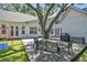 Spacious backyard with a large tree, wooden deck, grill, and seating area; perfect for outdoor entertaining and relaxation at 3209 W Morrison Ave, Tampa, FL 33629