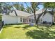 Lush backyard with a large grassy area, wooden deck, playground, and a majestic old oak tree providing ample shade at 3209 W Morrison Ave, Tampa, FL 33629