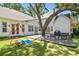 Expansive backyard featuring a wooden deck, playground equipment, and lush green lawn; ideal for Gathering fun and outdoor activities at 3209 W Morrison Ave, Tampa, FL 33629