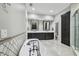 Bright bathroom featuring a soaking tub, double vanity, shower, toilet and elegant tile flooring at 3209 W Morrison Ave, Tampa, FL 33629