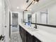 Bathroom featuring double sink vanity, decorative tile floor, and natural light at 3209 W Morrison Ave, Tampa, FL 33629