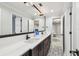 Bathroom featuring double sink vanity, decorative tile floor, and natural light at 3209 W Morrison Ave, Tampa, FL 33629