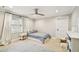 Cozy bedroom with plush carpet, neutral paint, natural light, and ceiling fan at 3209 W Morrison Ave, Tampa, FL 33629