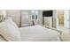 Bedroom featuring a white bed frame, shuttered window, and ensuite bathroom with glass shower at 3209 W Morrison Ave, Tampa, FL 33629