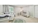 Bedroom featuring plush carpet, neutral paint, natural light, and baby furniture at 3209 W Morrison Ave, Tampa, FL 33629