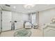 Bright Bedroom with modern chandelier, neutral walls and a comfortable seating area next to the bright sunny window at 3209 W Morrison Ave, Tampa, FL 33629