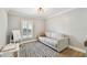 Bright bonus room features hardwood floors, neutral paint, natural light, and comfortable sitting area at 3209 W Morrison Ave, Tampa, FL 33629