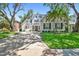 Charming white-brick home with mature trees, manicured lawn and long driveway at 3209 W Morrison Ave, Tampa, FL 33629