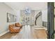 Bright foyer with two-story ceilings, light wood floors, tufted leather chairs and curved staircase at 3209 W Morrison Ave, Tampa, FL 33629