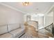 Hallway with hardwood floors, neutral paint, natural light, and staircase at 3209 W Morrison Ave, Tampa, FL 33629