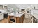 Kitchen island with stainless steel microwave and quartz countertop with seating, adjacent to the fireplace at 3209 W Morrison Ave, Tampa, FL 33629