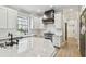 Beautiful kitchen featuring a large island, modern appliances, and sleek white cabinetry at 3209 W Morrison Ave, Tampa, FL 33629