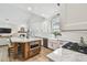 Spacious kitchen with a large center island, modern appliances, and open layout to the living room at 3209 W Morrison Ave, Tampa, FL 33629