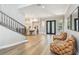 Elegant living room with hardwood floors, staircase, and views into the dining room at 3209 W Morrison Ave, Tampa, FL 33629