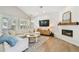 Bright and airy living room featuring a cozy fireplace, modern decor, and ample natural light at 3209 W Morrison Ave, Tampa, FL 33629