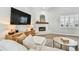 Comfortable living room with a fireplace, light wood floors, and a large television for entertainment at 3209 W Morrison Ave, Tampa, FL 33629