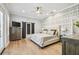 Stylish main bedroom with decorative accent wall, barn doors to the ensuite bath and access to the outdoors at 3209 W Morrison Ave, Tampa, FL 33629