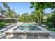 Beautiful in-ground pool and in ground spa surrounded by lush tropical landscaping at 3209 W Morrison Ave, Tampa, FL 33629