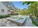 Stunning backyard showcasing a modern pool, spa, and tropical landscaping; creating a private and serene outdoor retreat at 3209 W Morrison Ave, Tampa, FL 33629