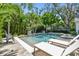 Resort style pool with lush landscaping, in ground spa and sunbathing deck at 3209 W Morrison Ave, Tampa, FL 33629