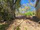 Landscaped backyard with a variety of trees and plants, creating a private outdoor space at 32348 Marchmont Cir, Dade City, FL 33523