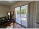 Bright bedroom featuring new laminate flooring, slider glass doors to deck, and neutral walls at 32348 Marchmont Cir, Dade City, FL 33523