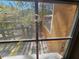 Exterior view from the window with a screened-in deck, a view of the lake, and exterior wall at 32348 Marchmont Cir, Dade City, FL 33523